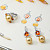Earrings with golden South Sea pearls, spessartite garnets, and diamonds